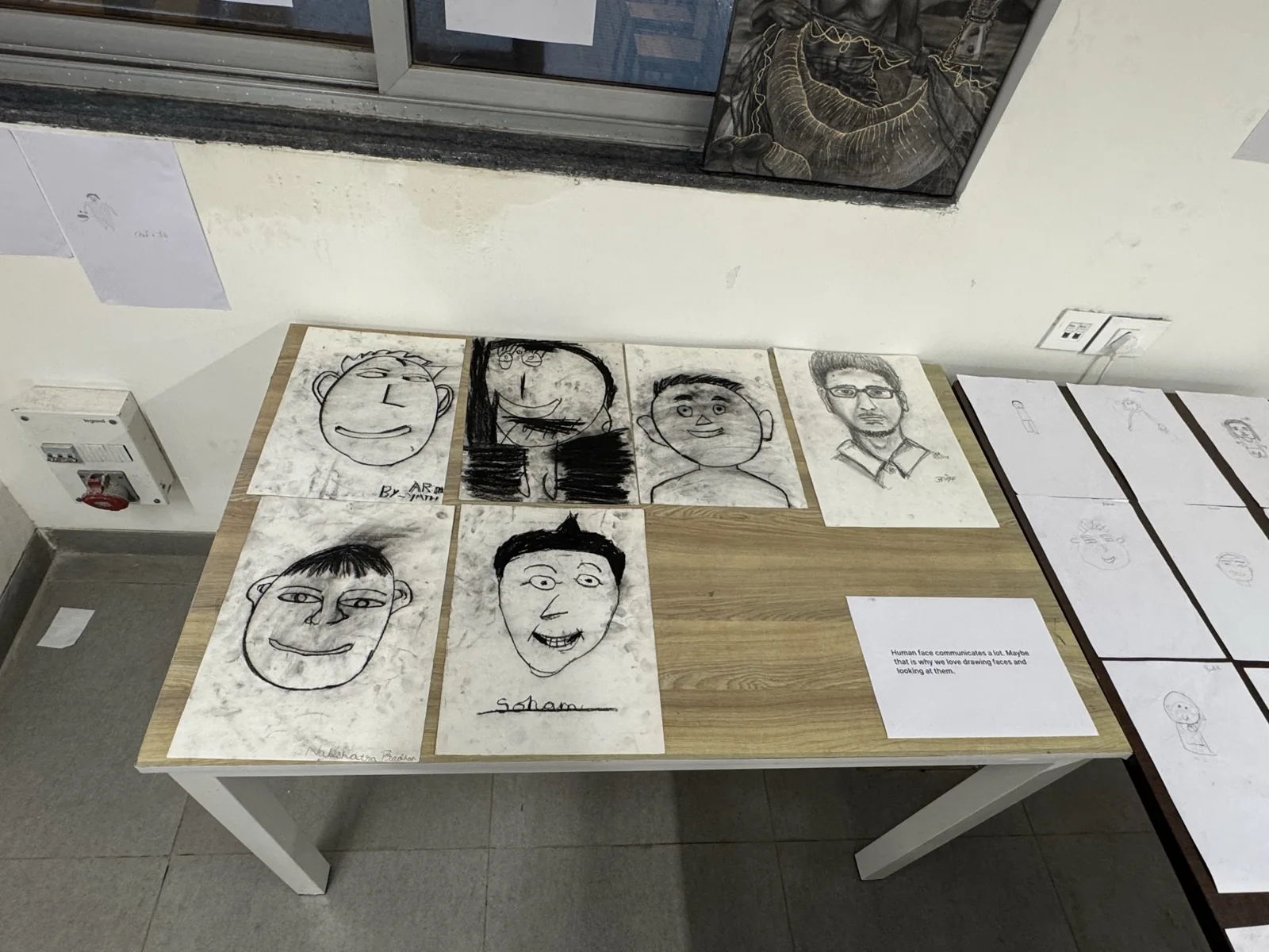 A table displaying several drawn portraits