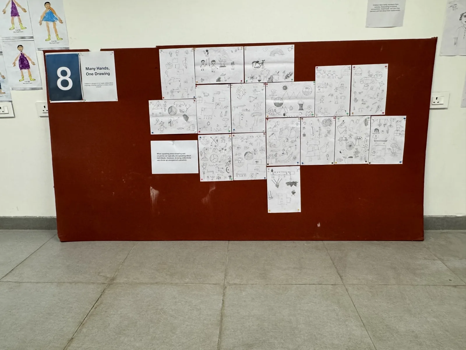 Story drawings arranged on a red exhibition panel