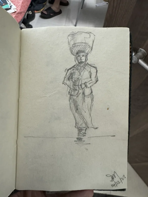 Pencil figure study on an open sketchbook page